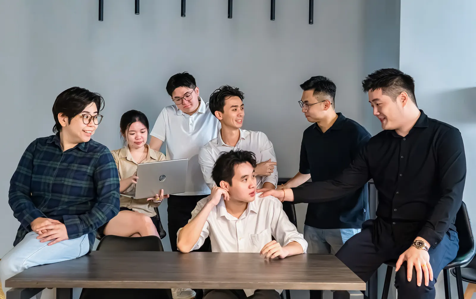 The Fincore team around a table, working through an open laptop
